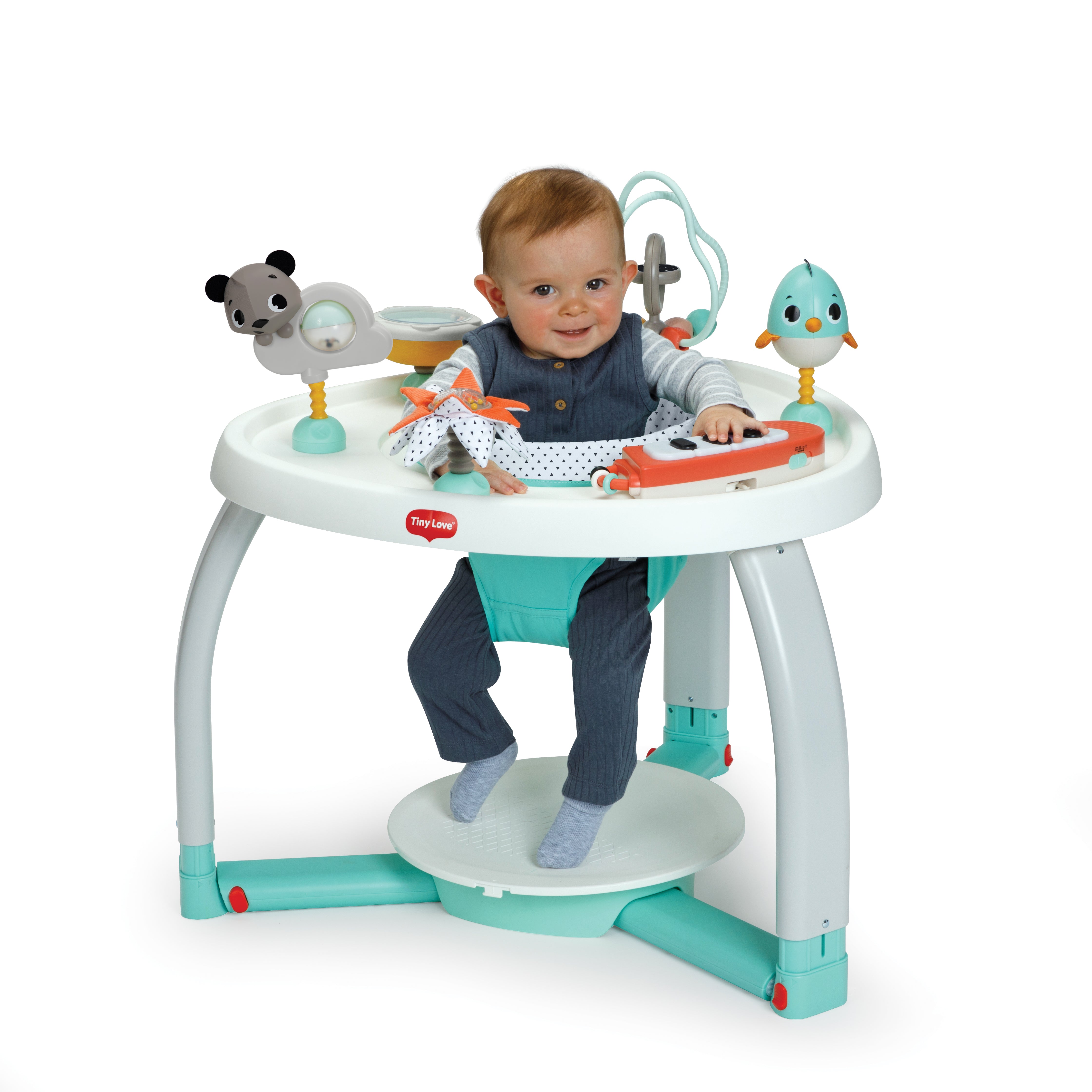 Toddler smiling in Tiny Love 5-in-1 Here I Grow Stationary Activity Center
