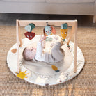 Luxe Developmental Gymini - baby playing with toys