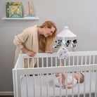 Magical Night 3-in-1 Projector Mobile - mother smiling at baby in crib